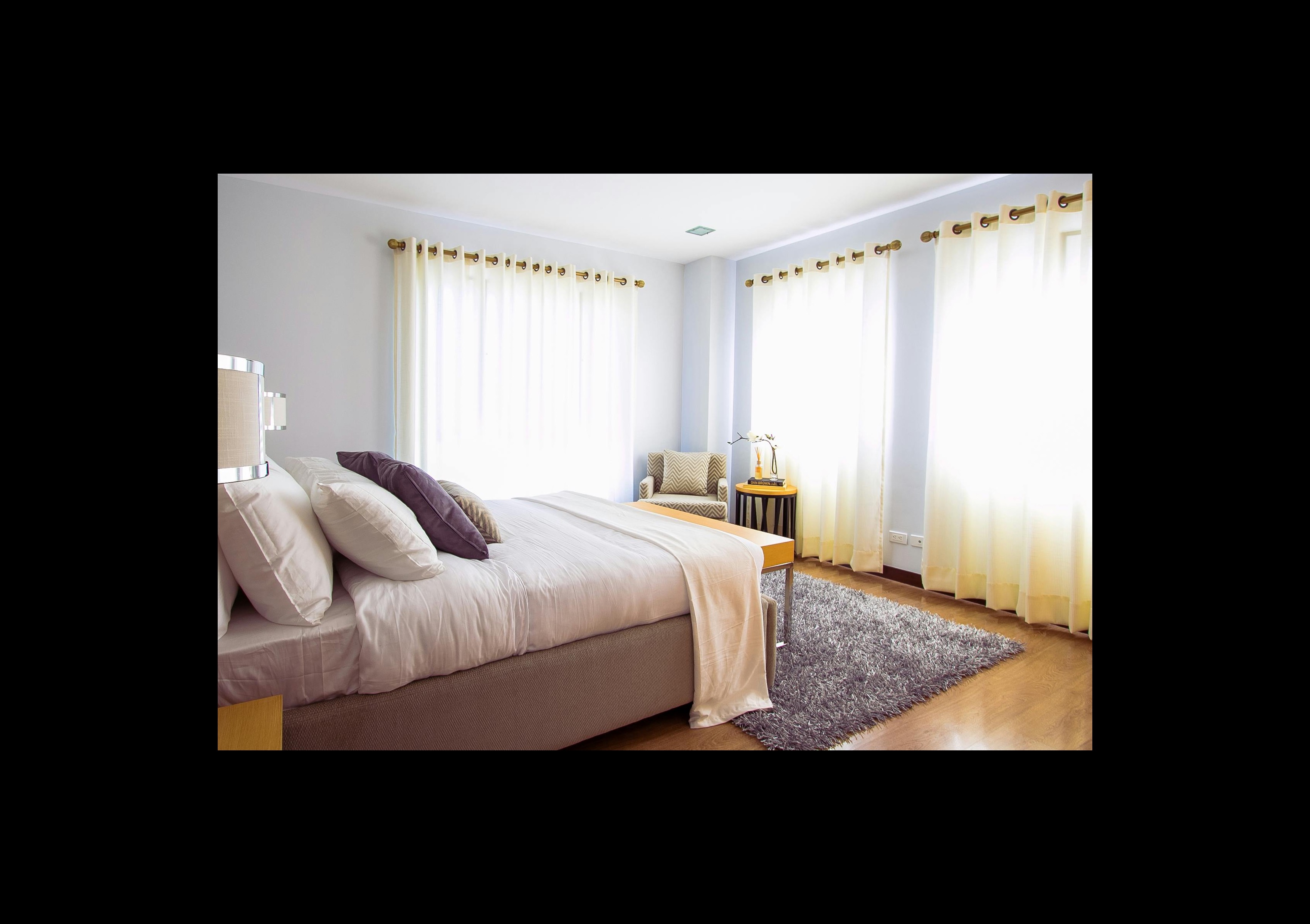 Bright bedroom with layered bedding and furniture